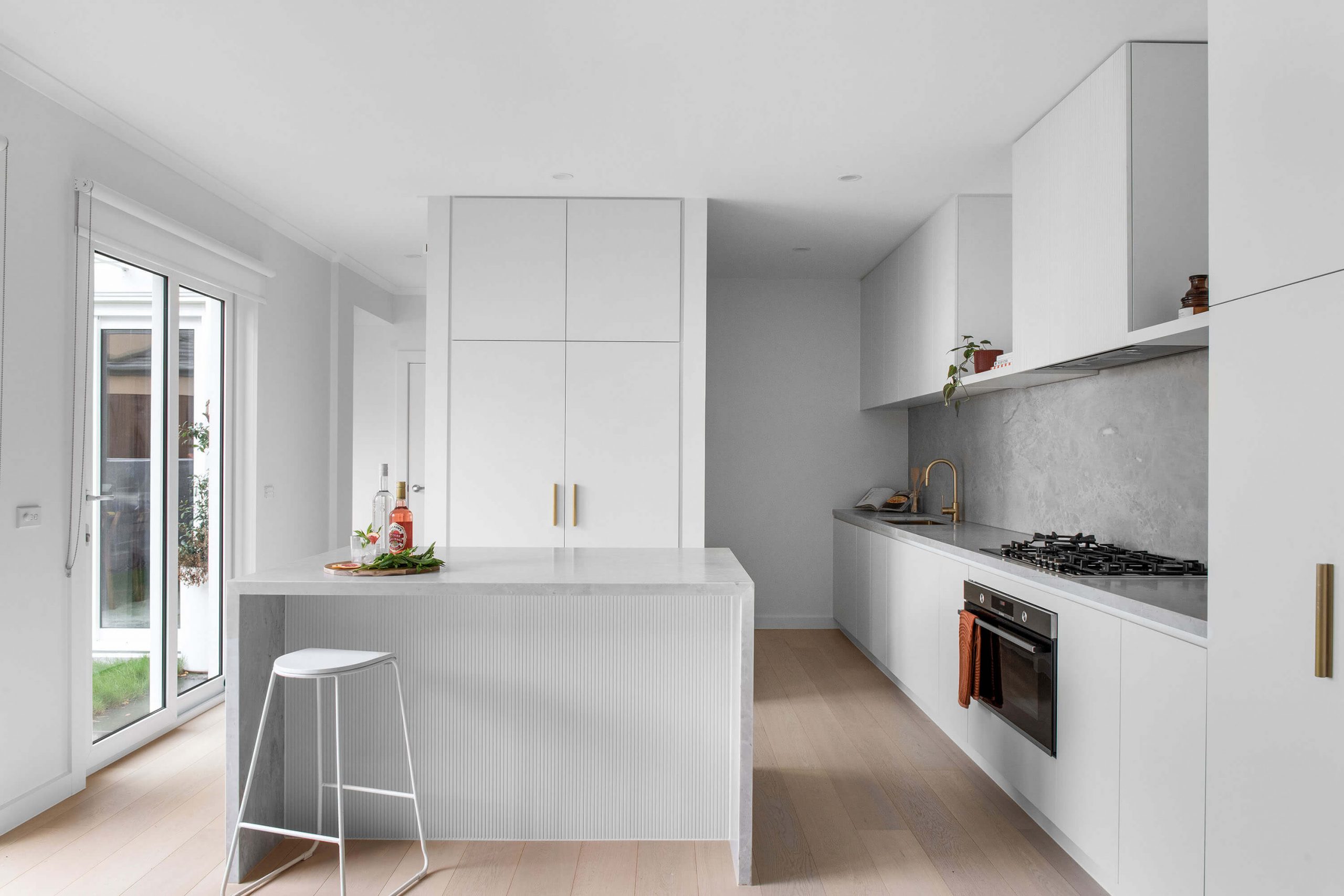 A custom designed kitchen featuring a custom island. Designed and built by MJ Harris Group.