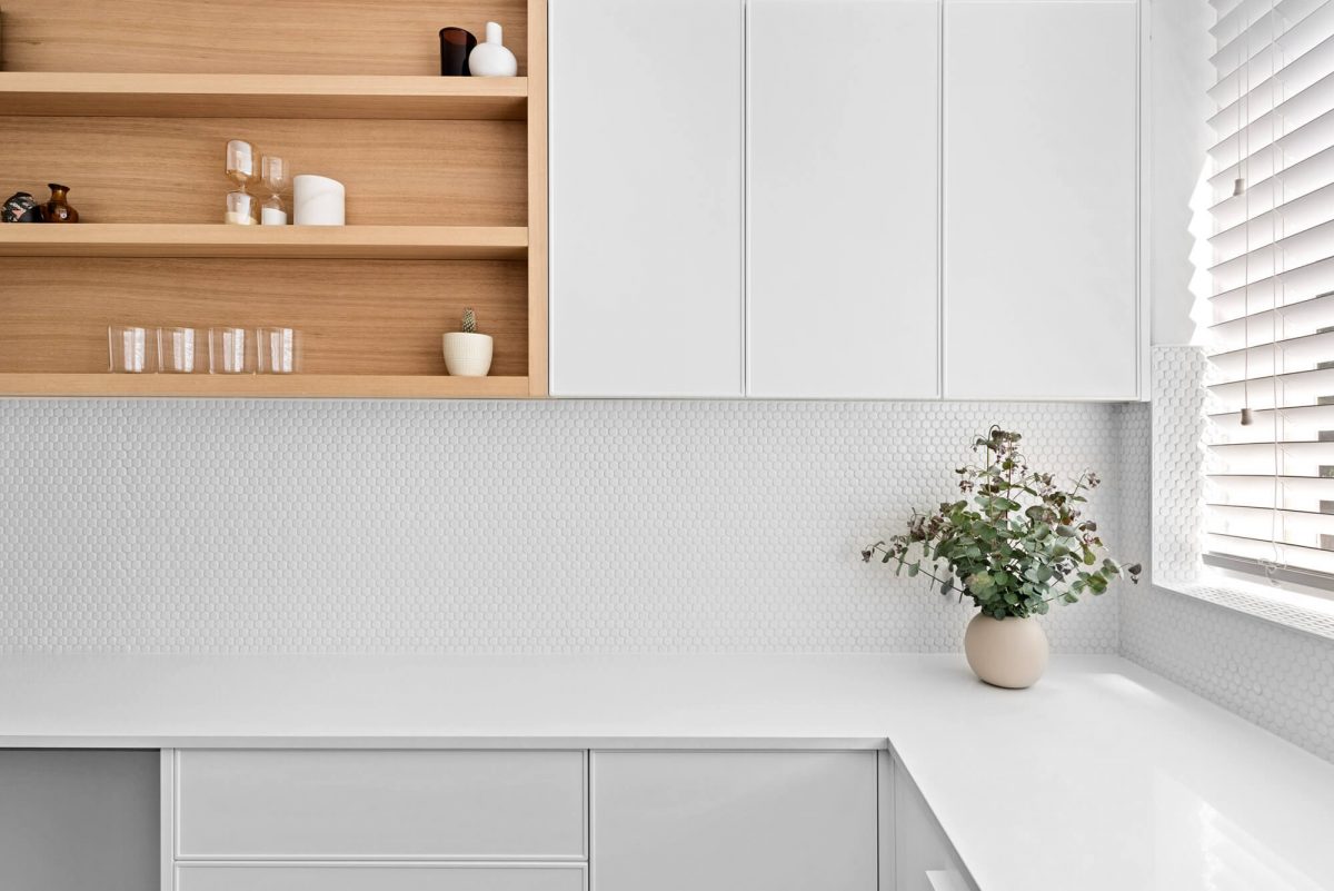 A custom designed kitchen with a timber and white design. Designed and built by MJ Harris Group.