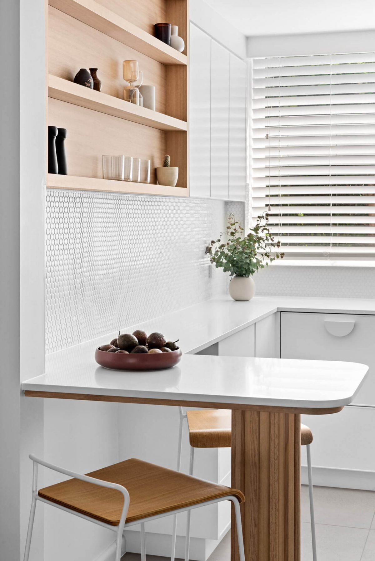 A custom designed kitchen with a timber and white design. Designed and built by MJ Harris Group.