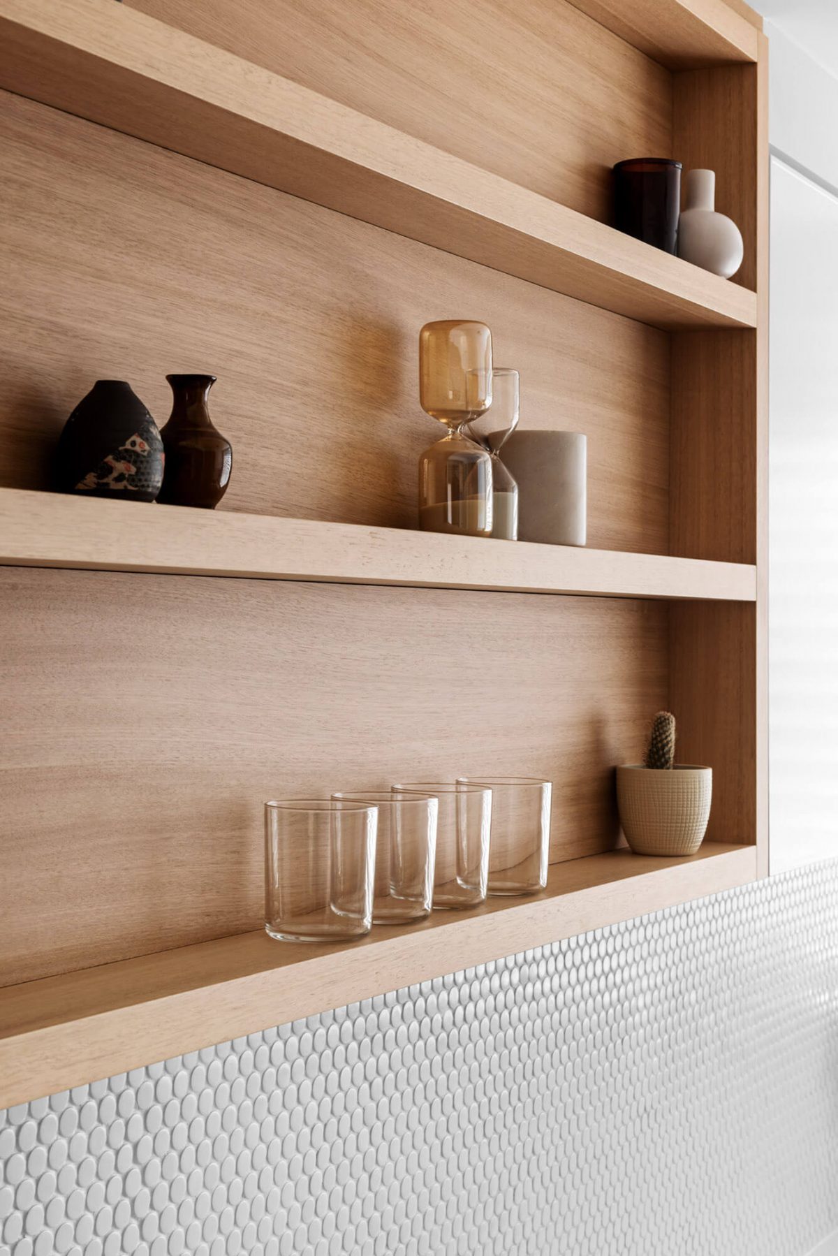 A custom designed kitchen with a timber and white design. Designed and built by MJ Harris Group.