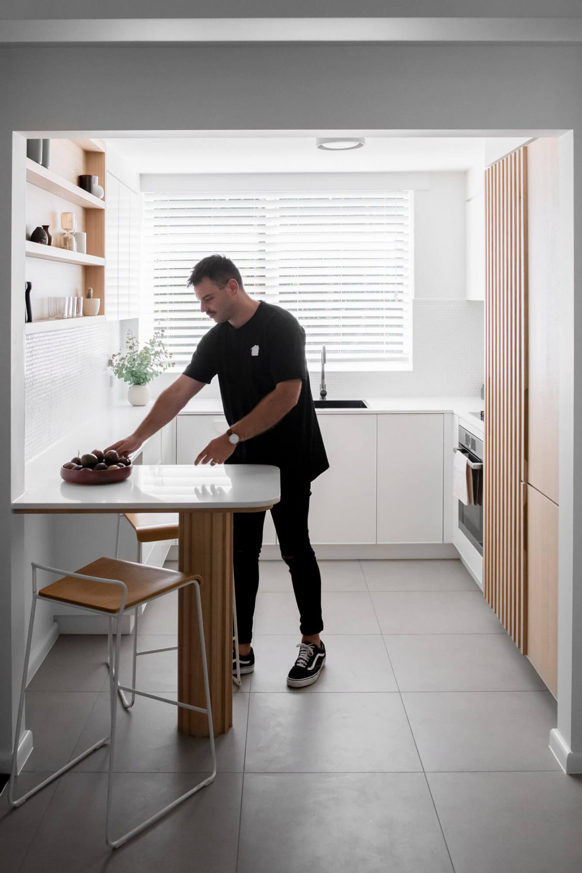 A custom designed kitchen with a timber and white design. Designed and built by MJ Harris Group.