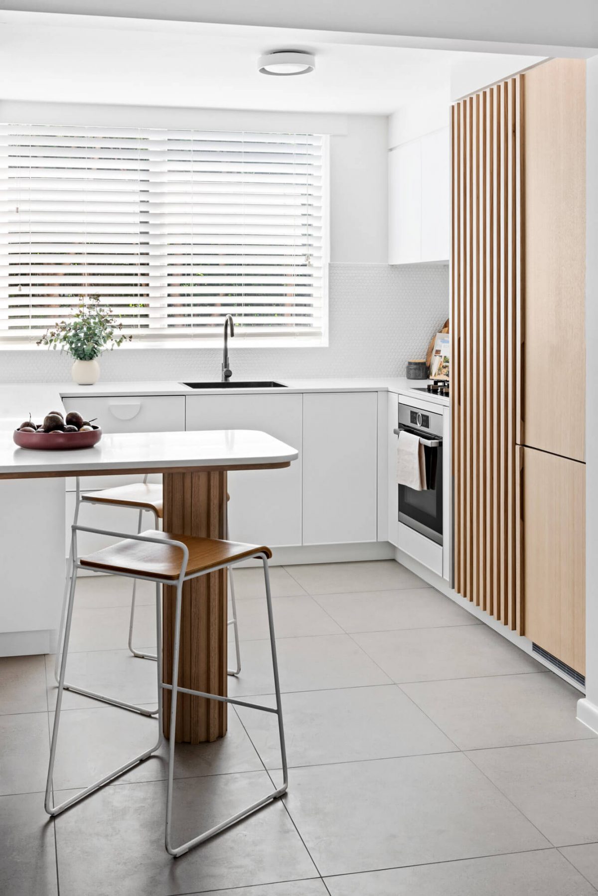 A custom designed kitchen with a timber and white design. Designed and built by MJ Harris Group.