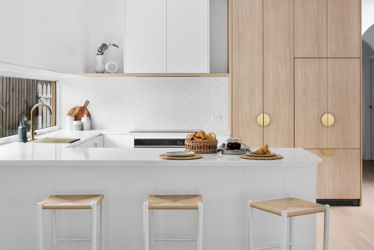 A custom designed kitchen featuring custom white joinery . Designed and built by MJ Harris Group.