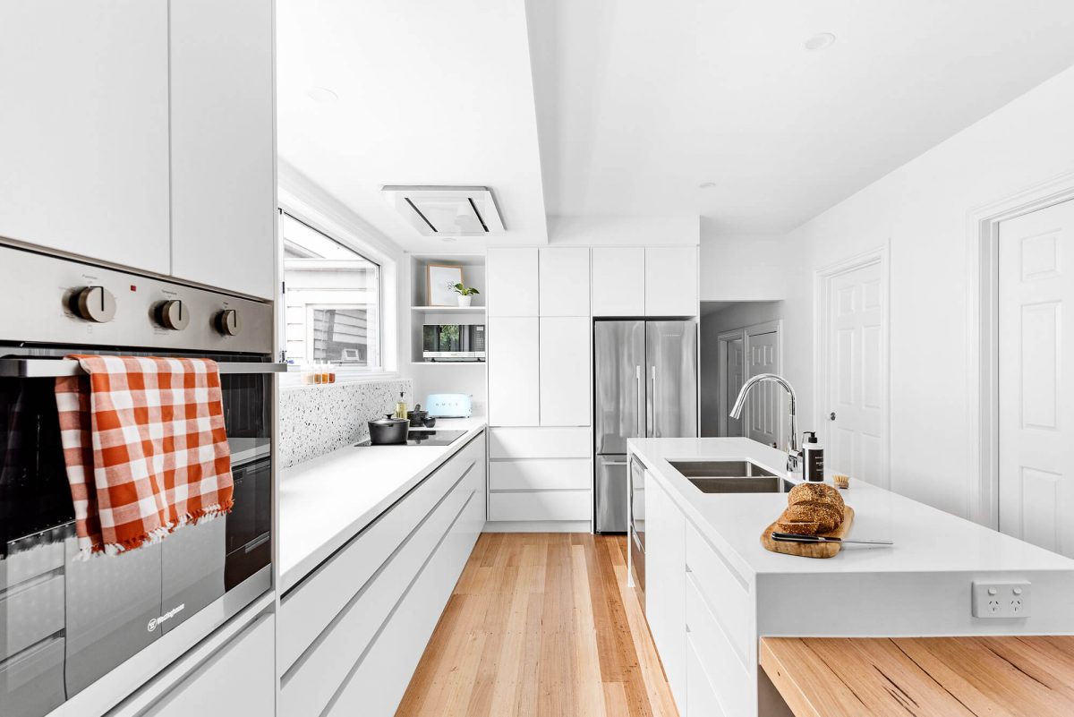 A custom designed white kitchen. Designed and built by MJ Harris Group.
