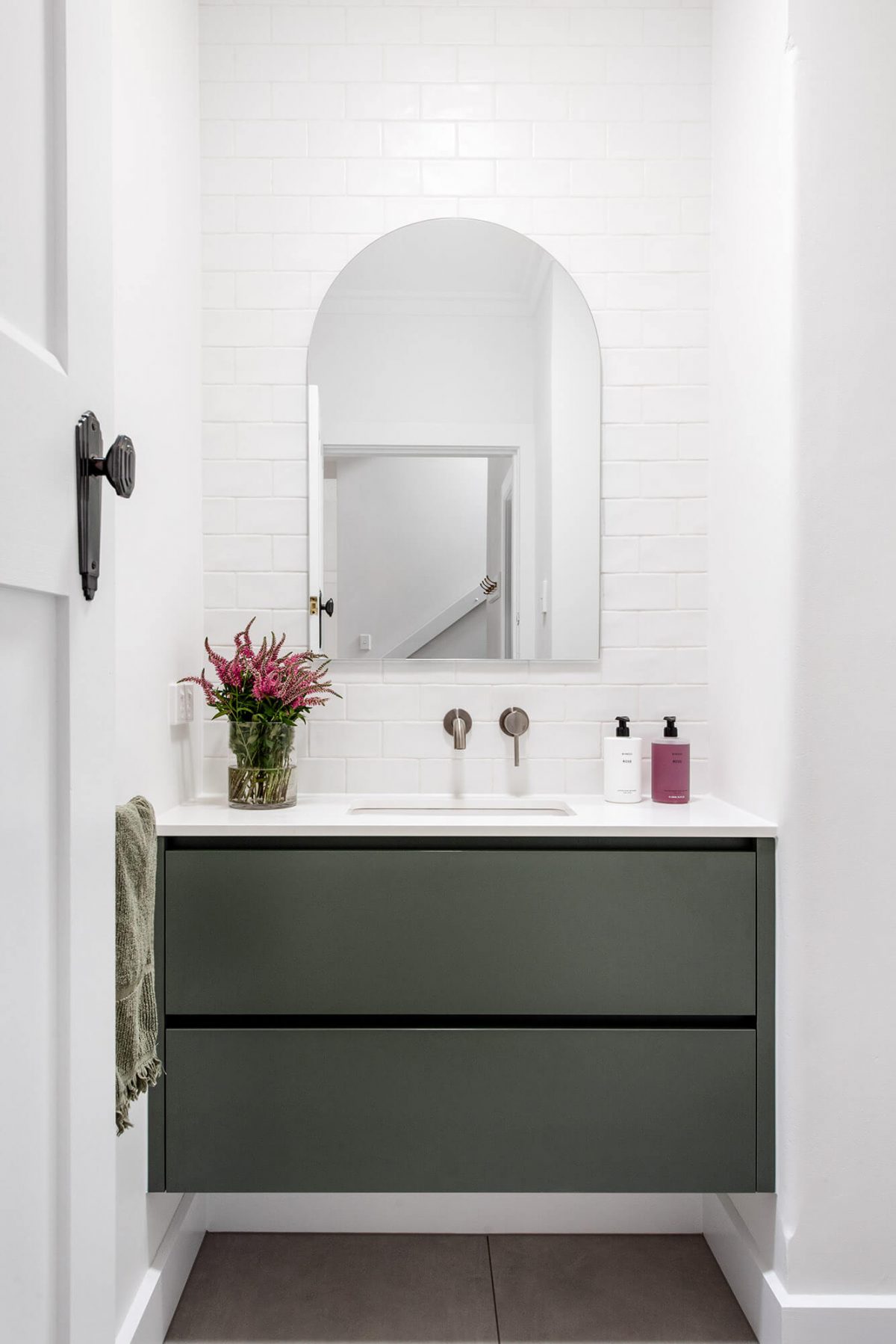 A custom designed bathroom featuring green joinery. Designed and built by MJ Harris Group.