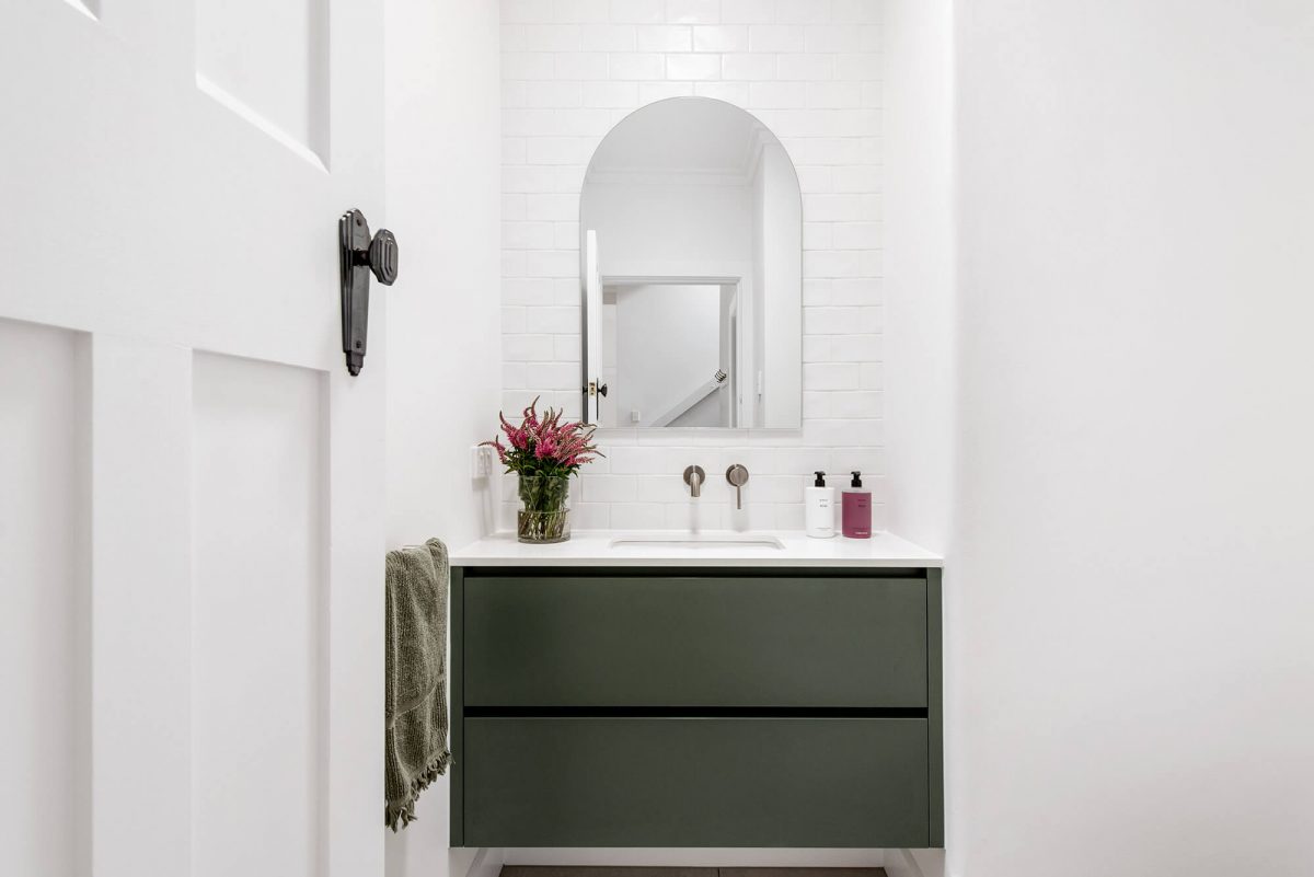 A custom designed bathroom featuring green joinery. Designed and built by MJ Harris Group.