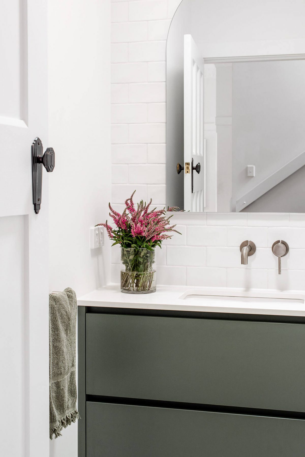 A custom designed bathroom featuring green joinery. Designed and built by MJ Harris Group.