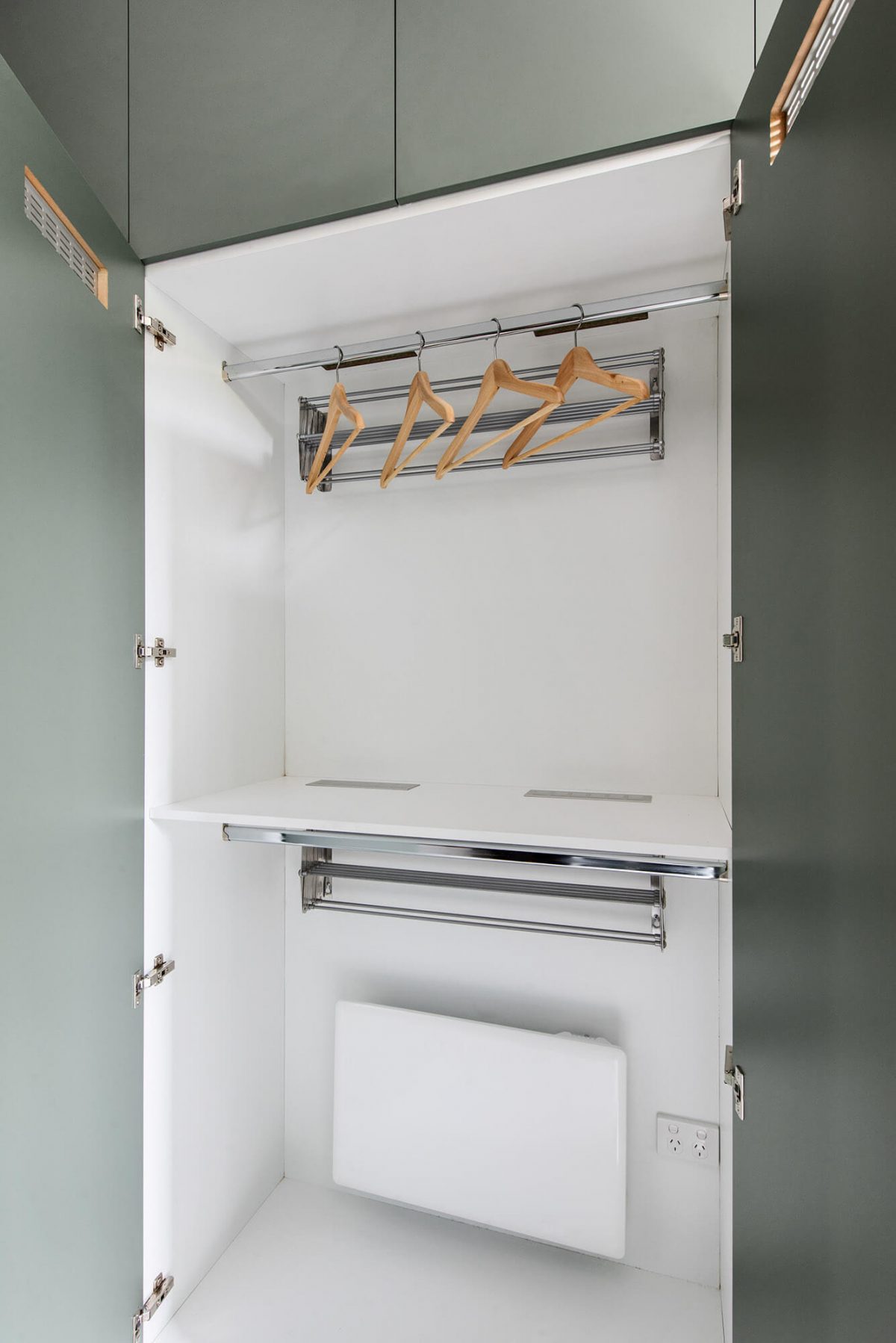 A custom designed laundry featuring green joinery. Designed and built by MJ Harris Group.