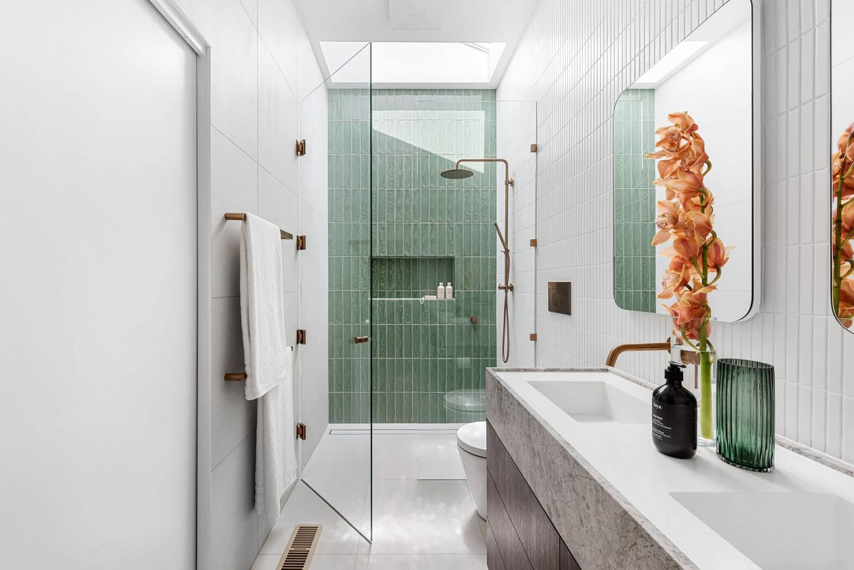 A custom designed bathroom featuring green tiles. Designed and built by MJ Harris Group.