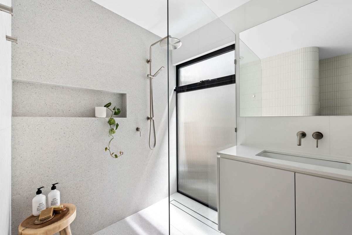 A custom designed ensuite bathroom featuring a grey tiles. Designed and built by MJ Harris Group. #MJHxEdinburghSt