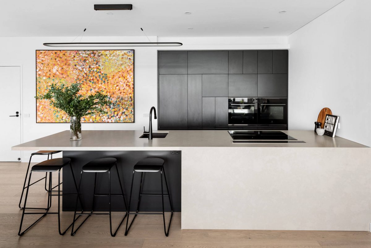 A custom designed monochromatic kitchen. Designed and built by MJ Harris Group.