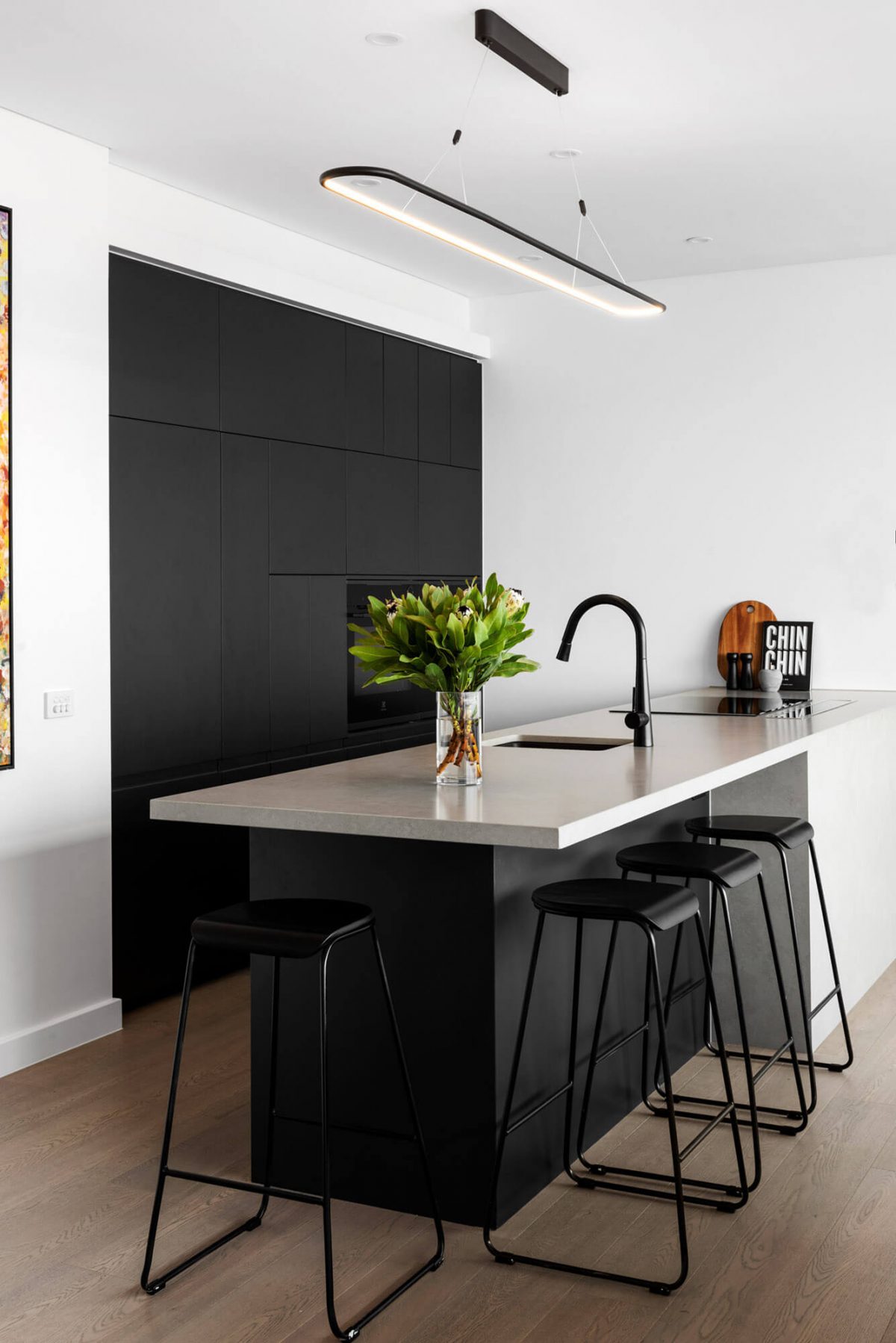 A custom designed monochromatic kitchen. Designed and built by MJ Harris Group.