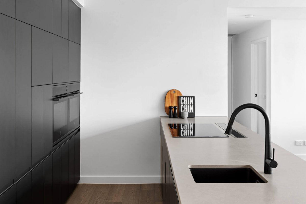 A custom designed monochromatic kitchen. Designed and built by MJ Harris Group.