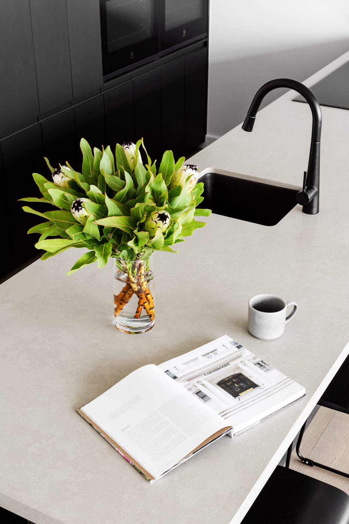 A custom designed monochromatic kitchen. Designed and built by MJ Harris Group.