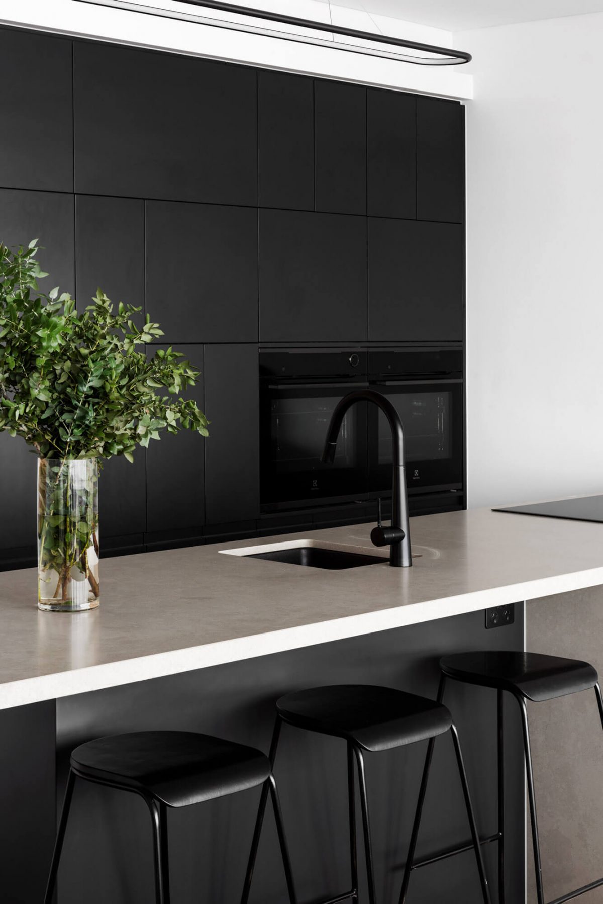 A custom designed monochromatic kitchen. Designed and built by MJ Harris Group.