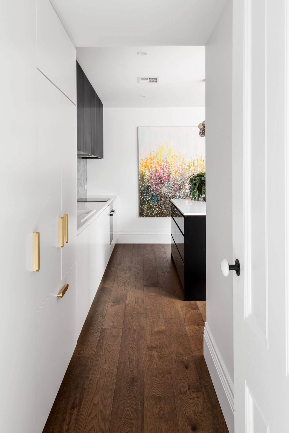 A custom designed monochromatic kitchen. Designed and built by MJ Harris Group.