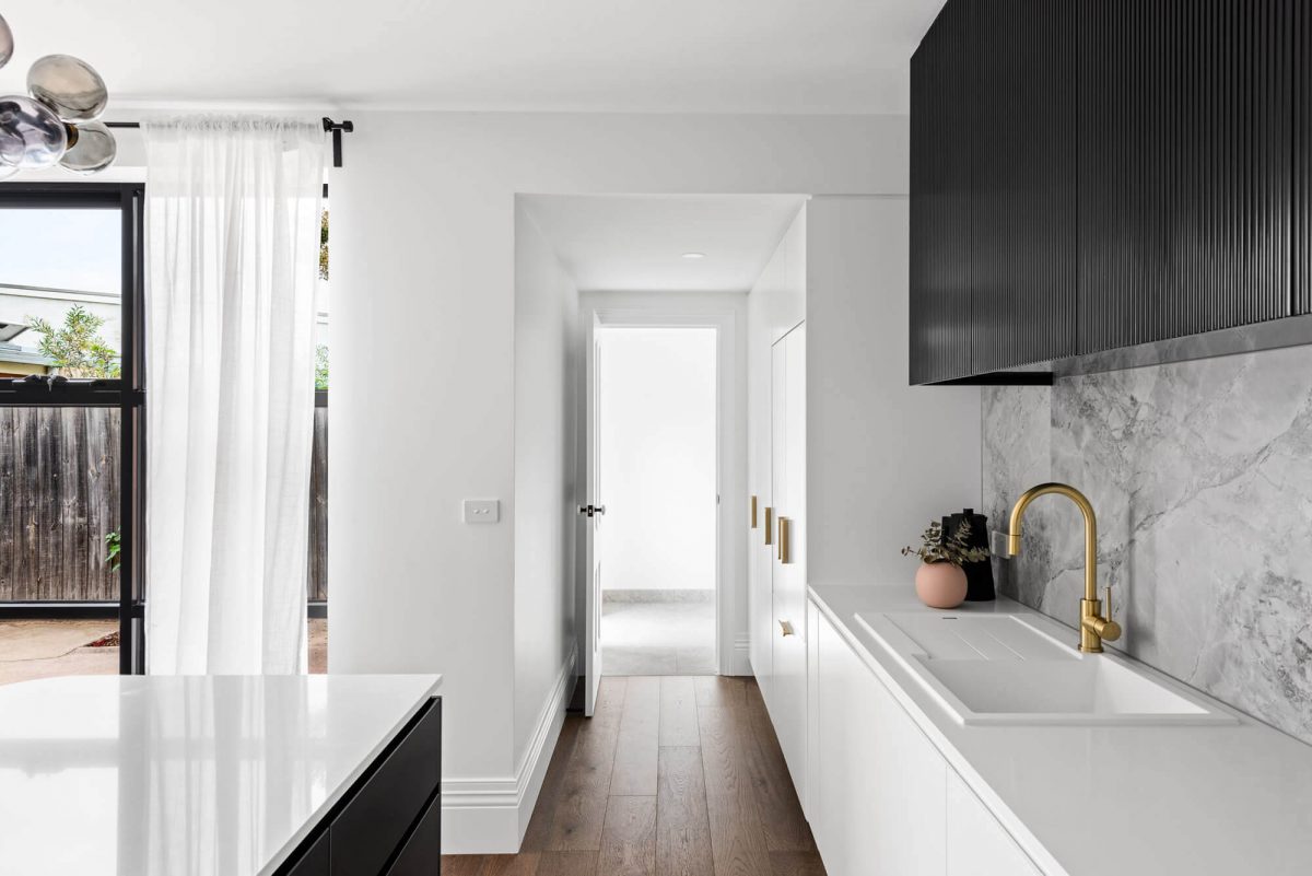 A custom designed monochromatic kitchen. Designed and built by MJ Harris Group.