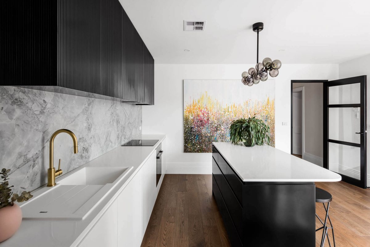 A custom designed monochromatic kitchen. Designed and built by MJ Harris Group.