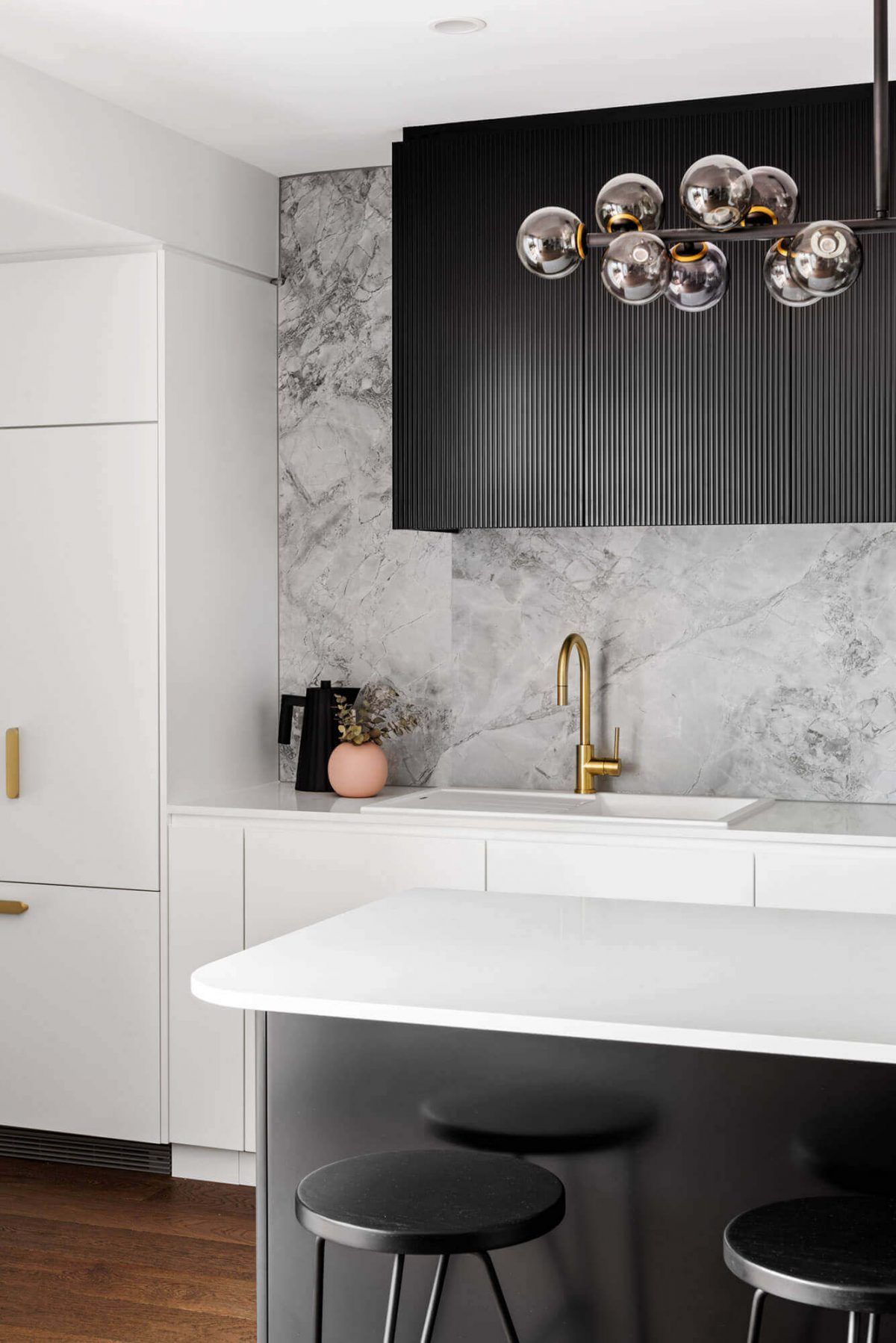 A custom designed monochromatic kitchen. Designed and built by MJ Harris Group.