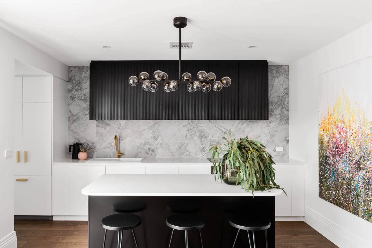 A custom designed kitchen with a black and white design. Designed and built by MJ Harris Group.