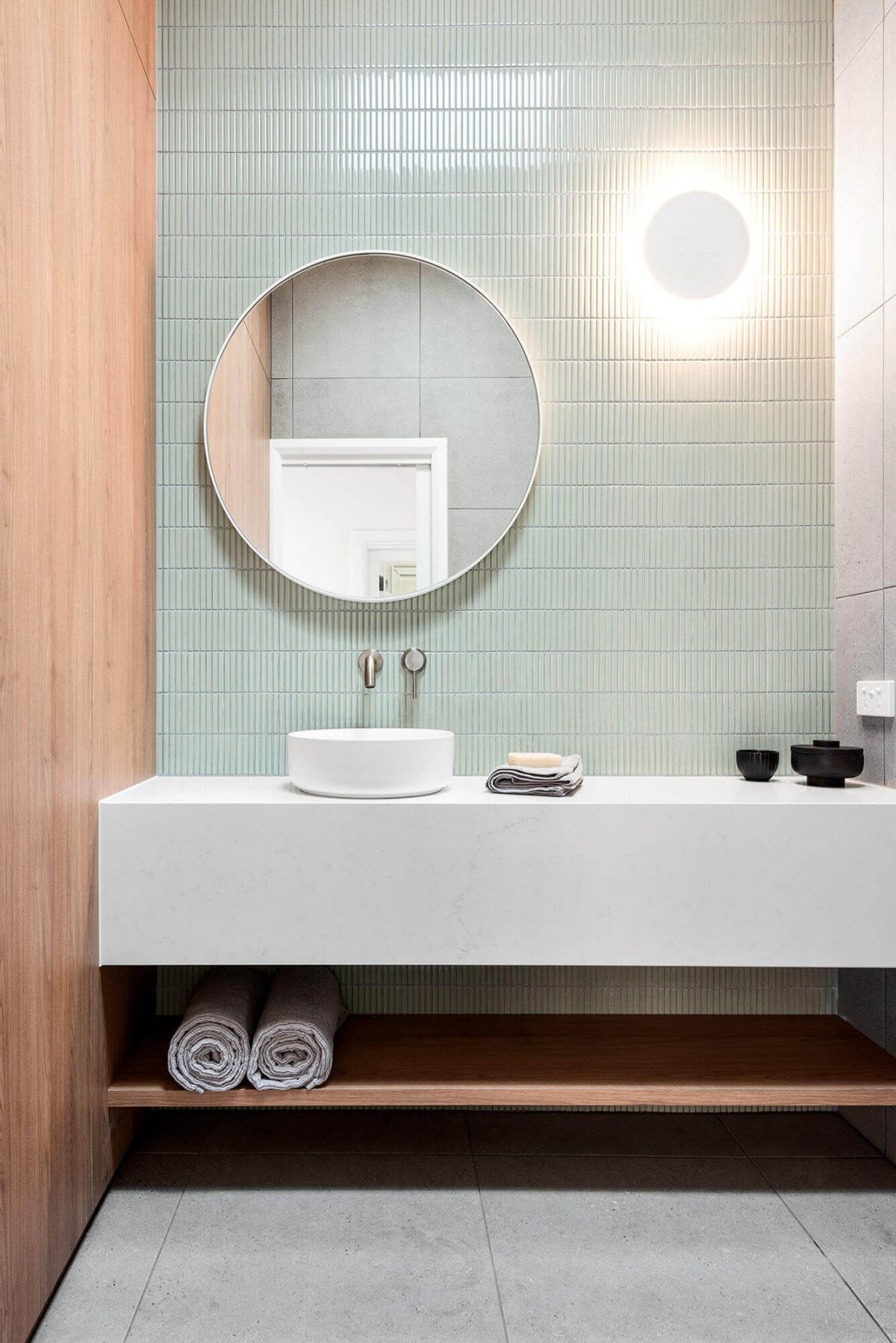 A custom designed laundry featuring green tiles. Designed and built by MJ Harris Group.