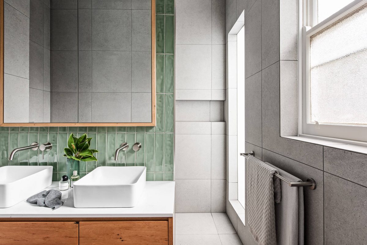 A custom designed bathroom featuring green tiles. Designed and built by MJ Harris Group.