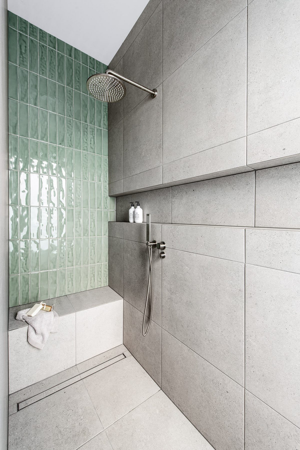 A custom designed bathroom featuring green tiles. Designed and built by MJ Harris Group.
