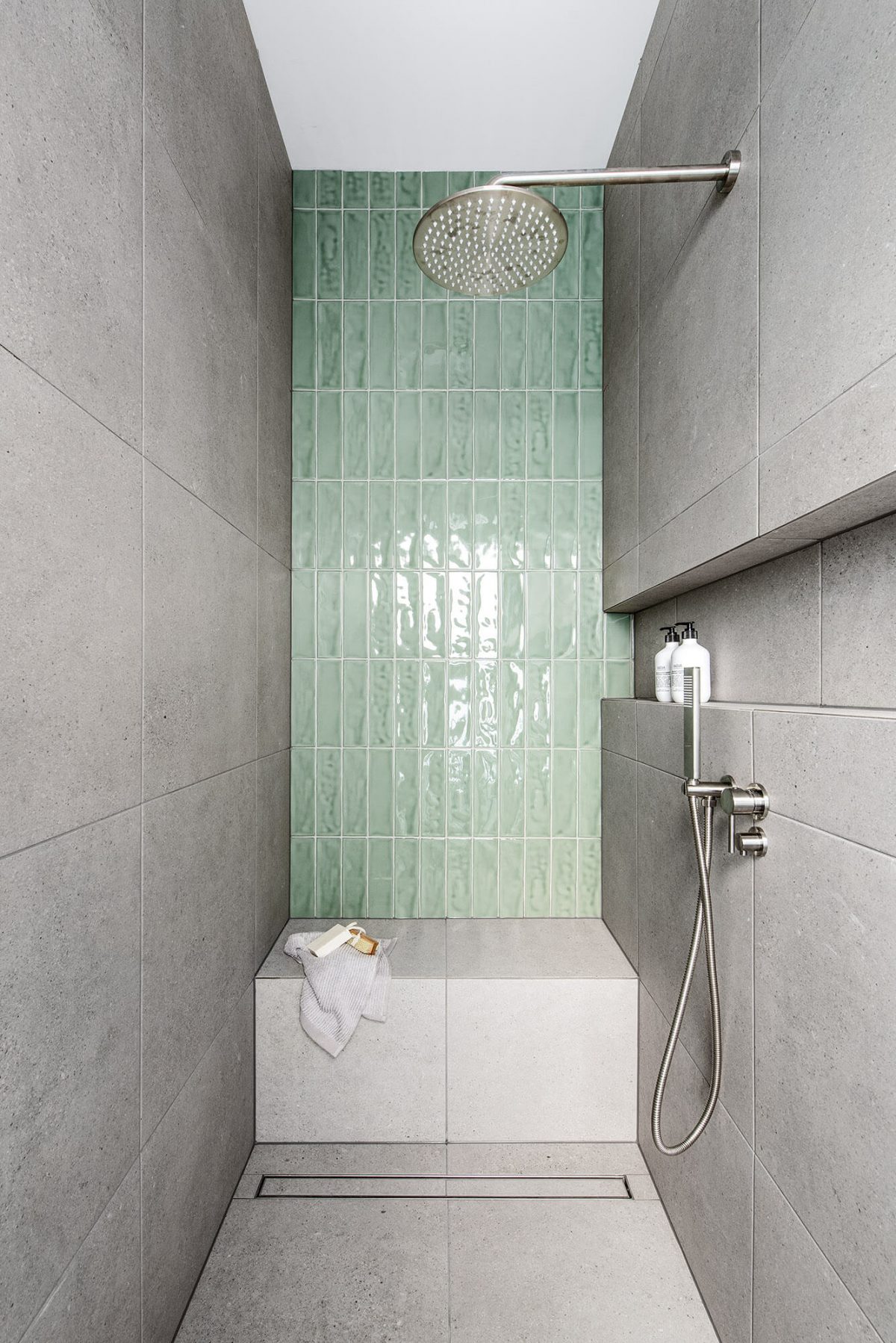 A custom designed bathroom featuring green tiles. Designed and built by MJ Harris Group.