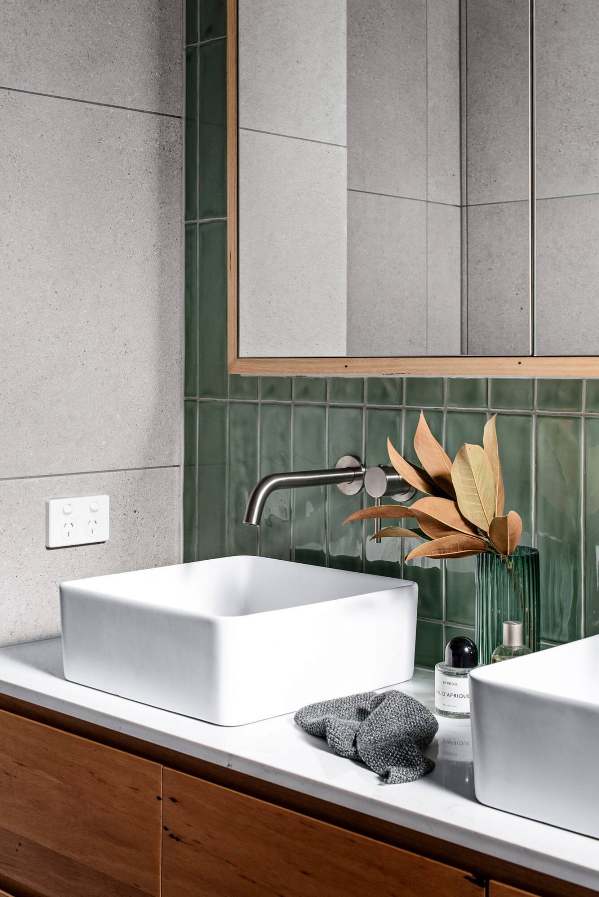 A custom designed bathroom featuring green tiles. Designed and built by MJ Harris Group.