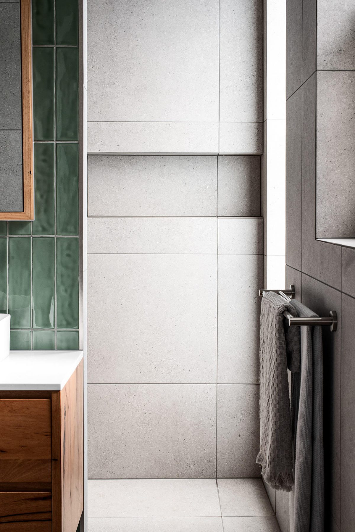 A custom designed bathroom featuring green tiles. Designed and built by MJ Harris Group.
