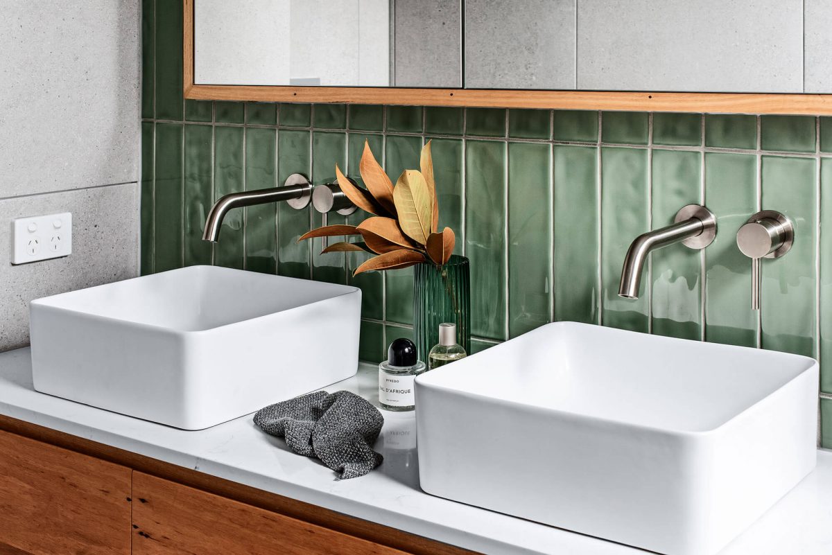 A custom designed bathroom featuring green tiles. Designed and built by MJ Harris Group.