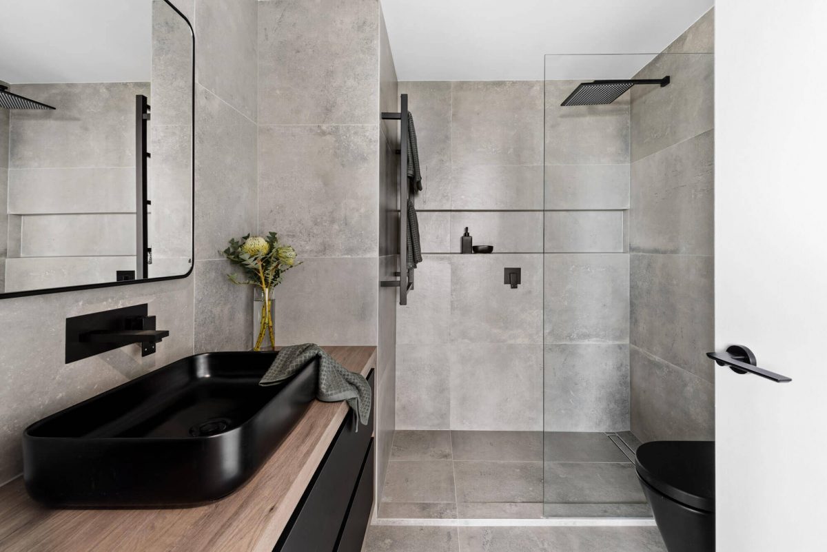 A custom designed monochromatic bathroom. Designed and built by MJ Harris Group.