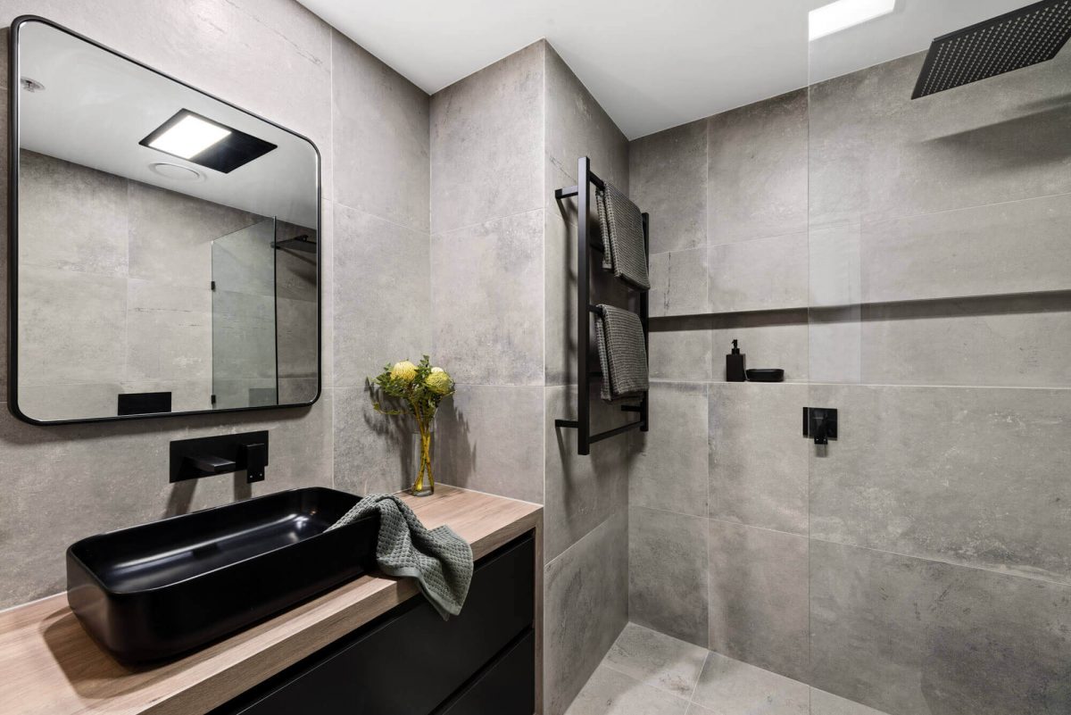 A custom designed monochromatic bathroom. Designed and built by MJ Harris Group.