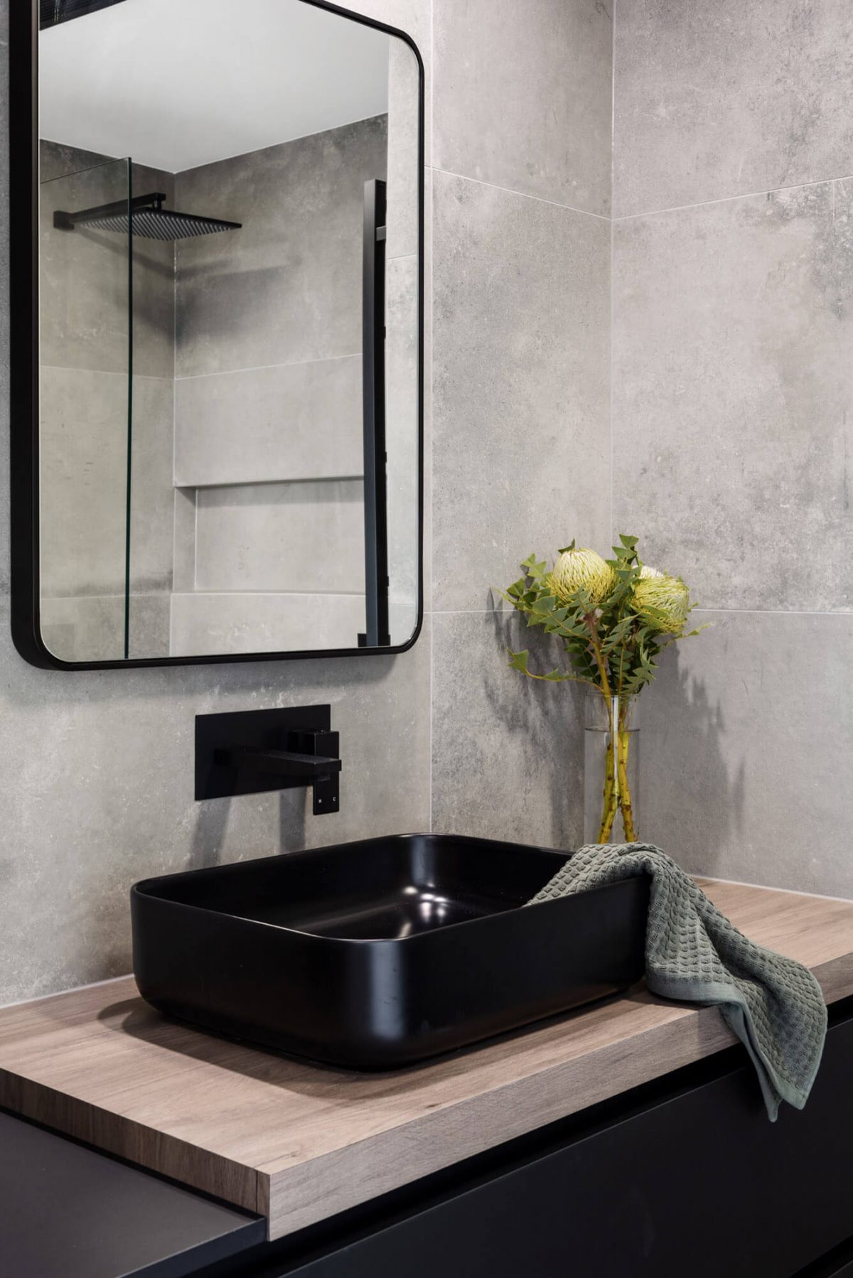 A custom designed monochromatic bathroom. Designed and built by MJ Harris Group.