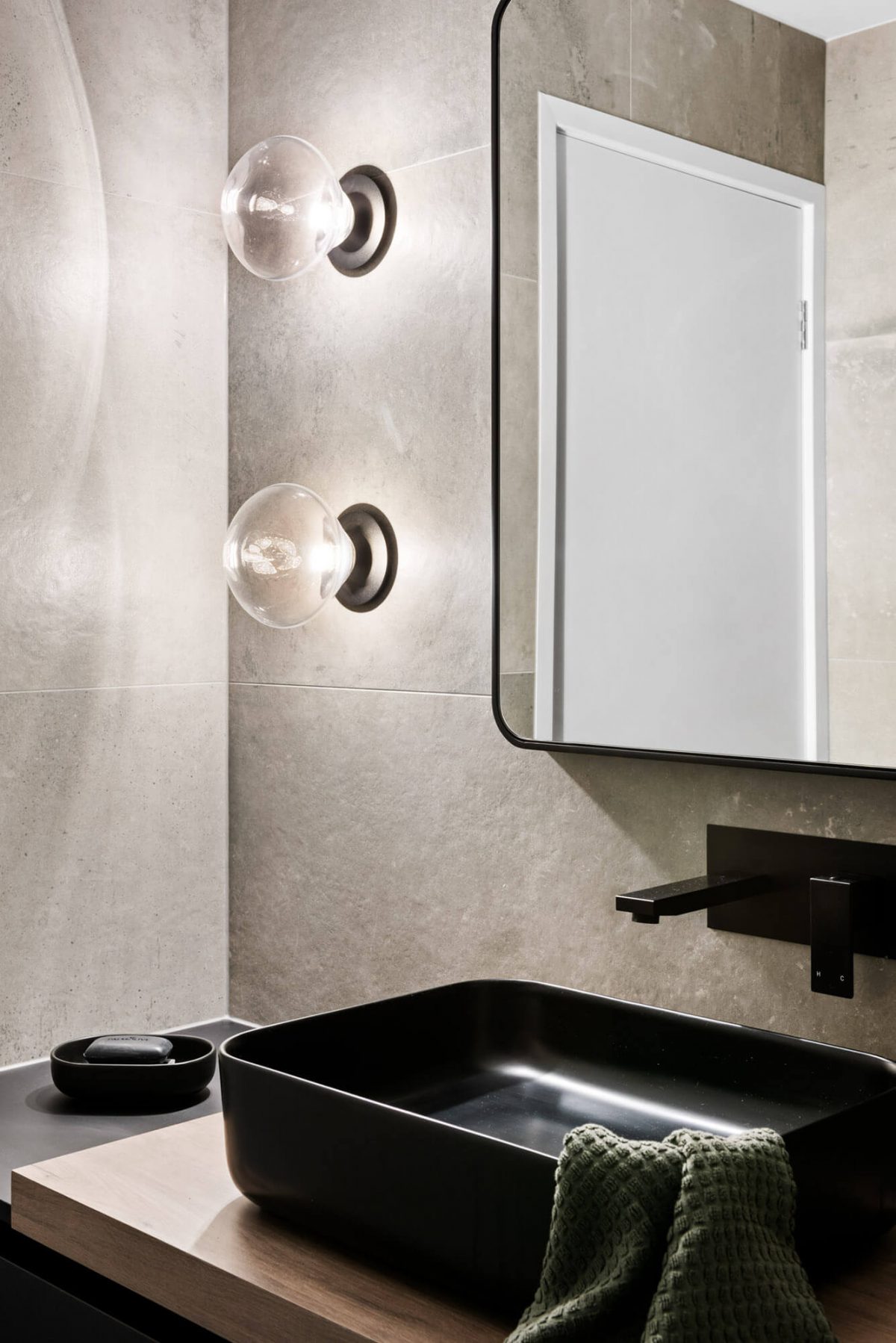 A custom designed monochromatic bathroom. Designed and built by MJ Harris Group.
