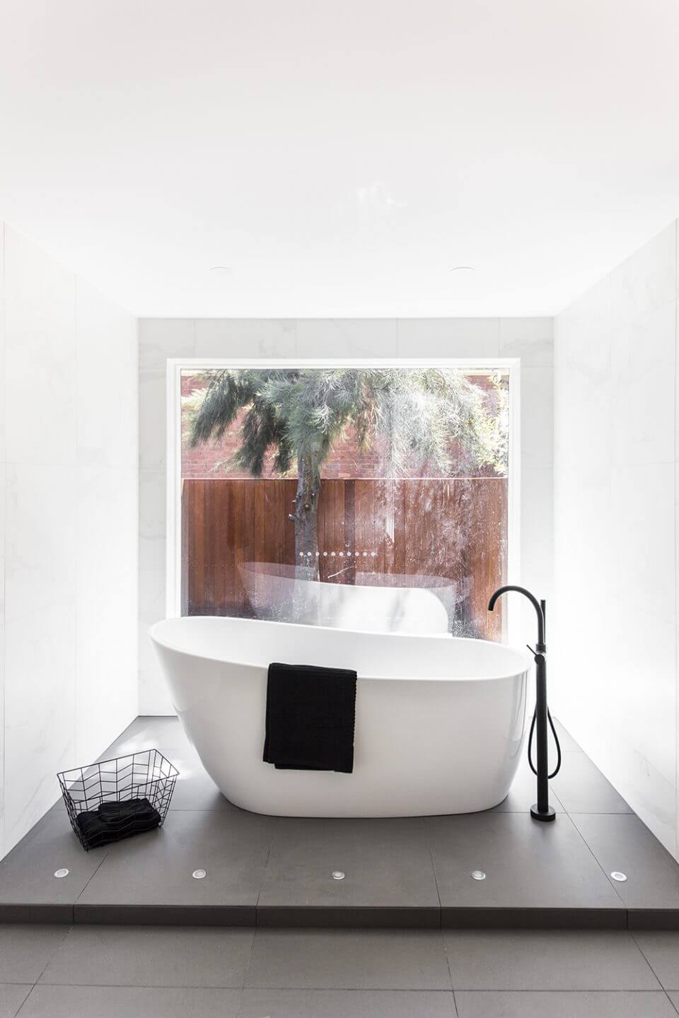 A custom designed bathroom featuring a free standing bath tub. Designed and built by MJ Harris Group.