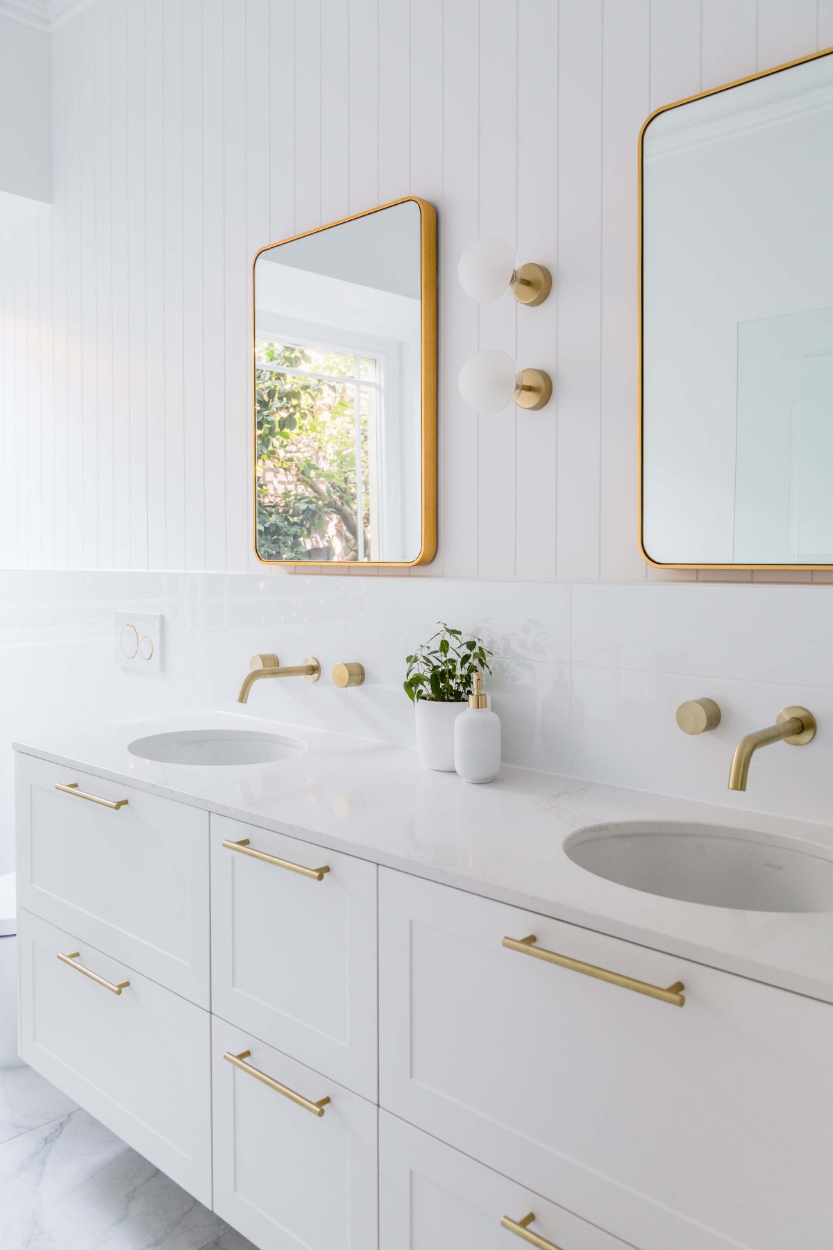A custom designed bathroom featuring gold fixtures. Designed and built by MJ Harris Group. #MJHxSycamoreSt