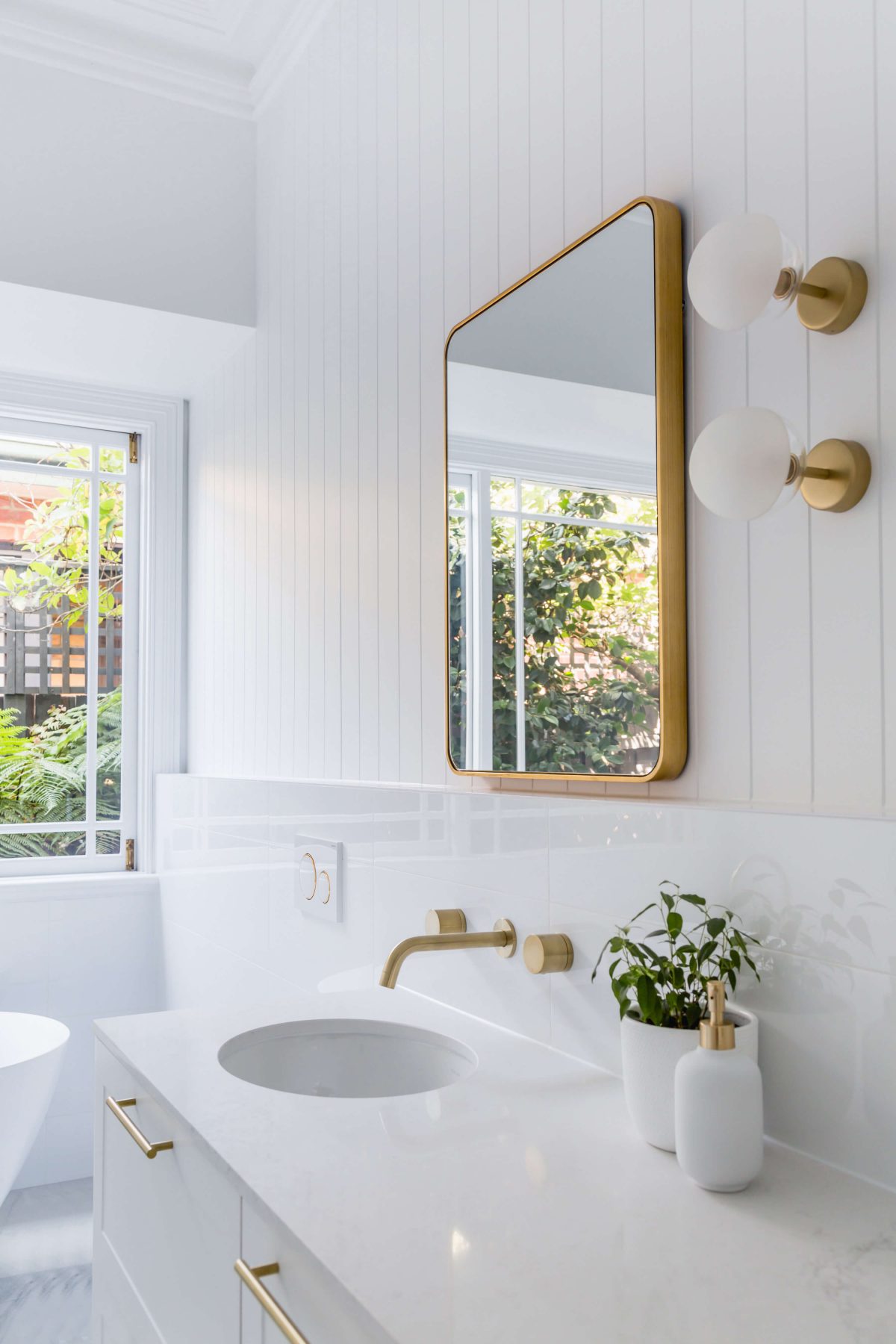 A custom designed bathroom featuring gold fixtures. Designed and built by MJ Harris Group. #MJHxSycamoreSt