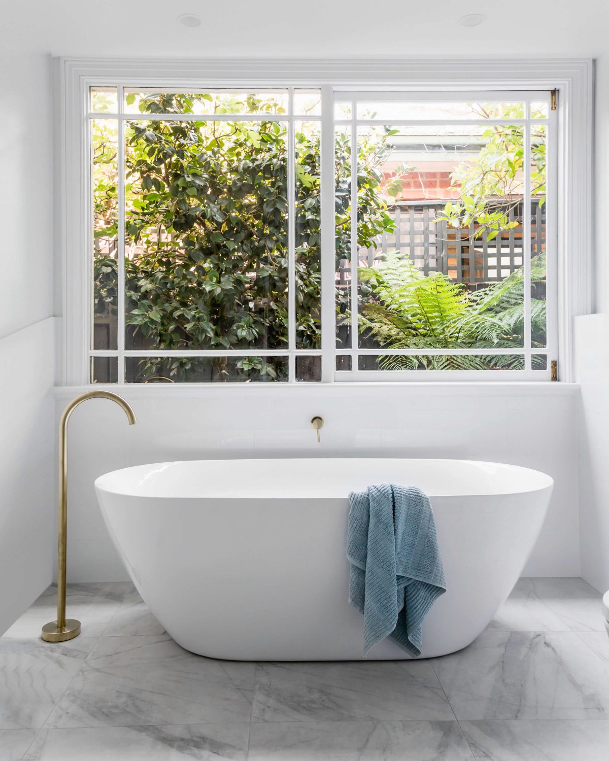 A custom designed bathroom featuring gold fixtures. Designed and built by MJ Harris Group. #MJHxSycamoreSt
