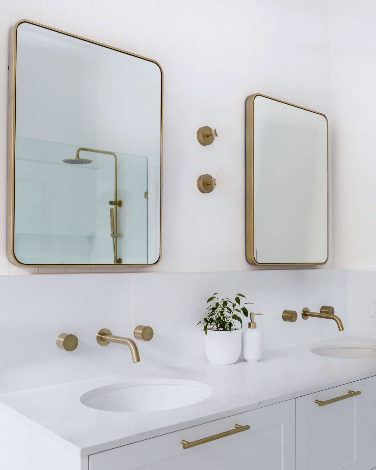 A custom designed bathroom featuring gold fixtures. Designed and built by MJ Harris Group. #MJHxSycamoreSt