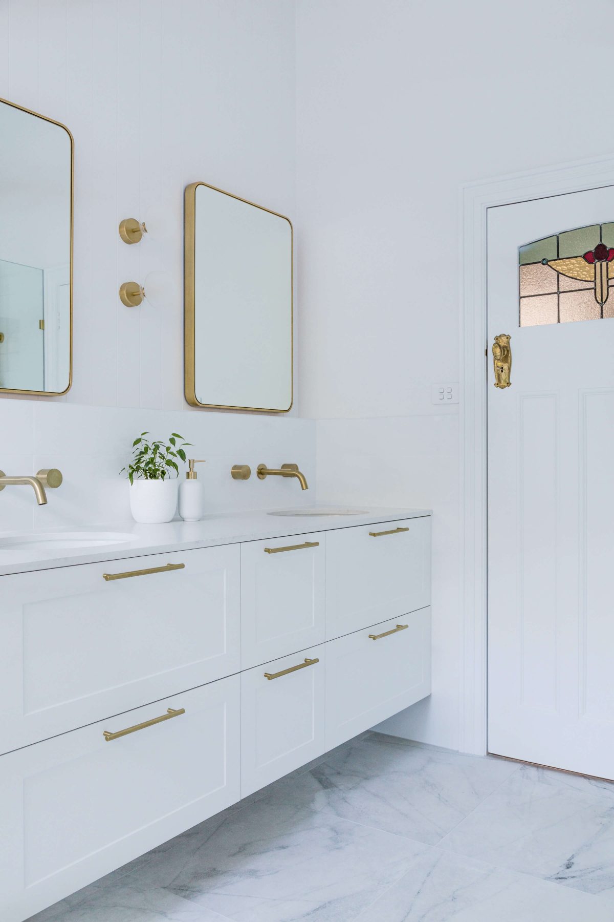 A custom designed bathroom featuring gold fixtures. Designed and built by MJ Harris Group. #MJHxSycamoreSt