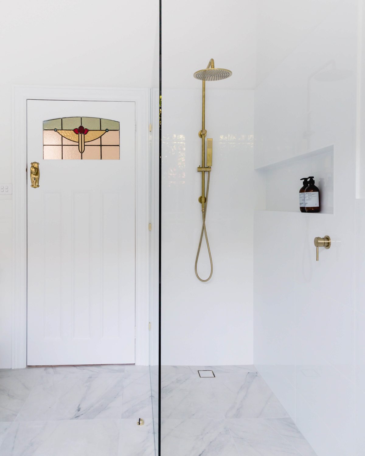 A custom designed bathroom featuring gold fixtures. Designed and built by MJ Harris Group. #MJHxSycamoreSt