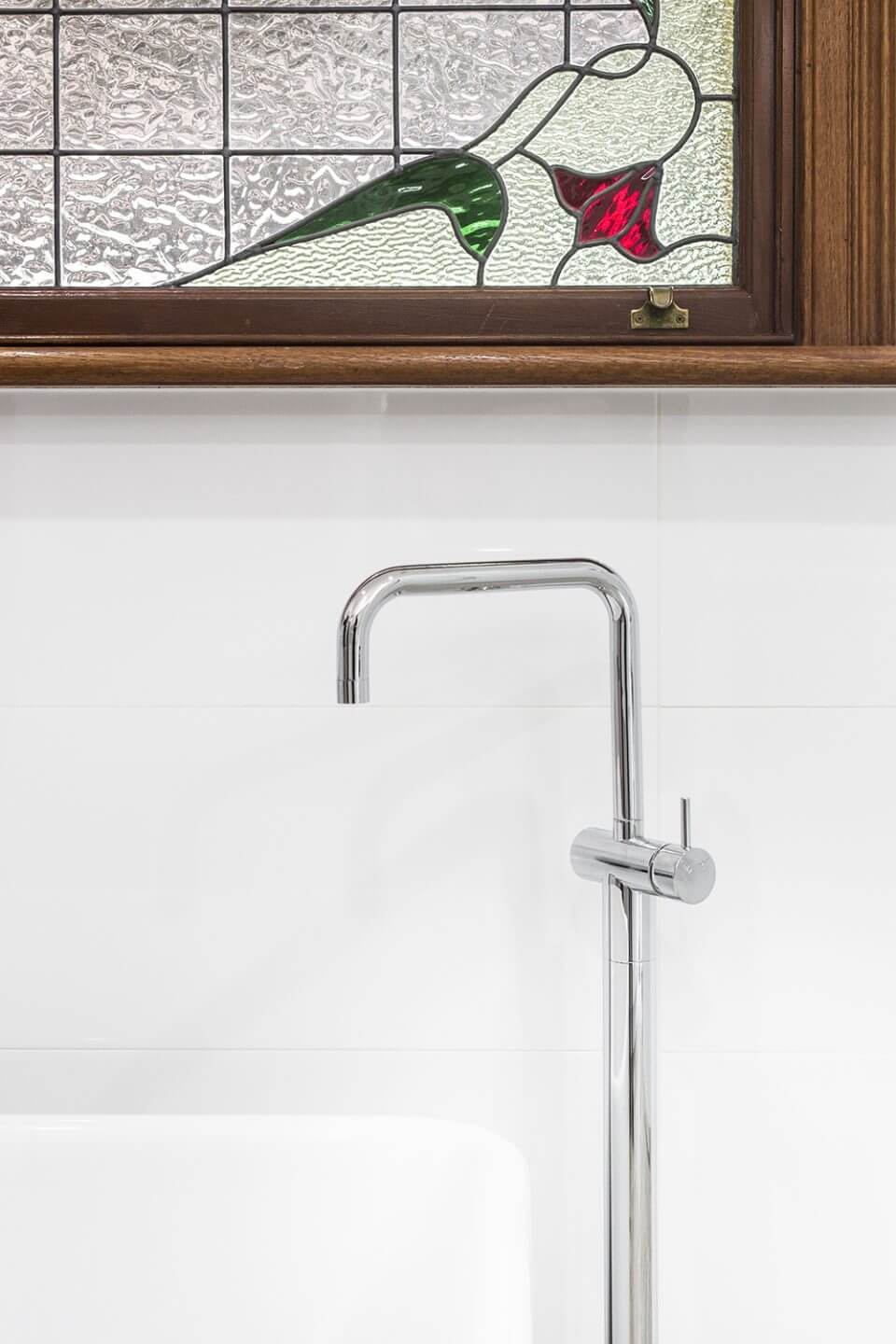 A custom designed bathroom featuring a free standing bath tub and freestanding chrome tapware. Designed and built by MJ Harris Group.