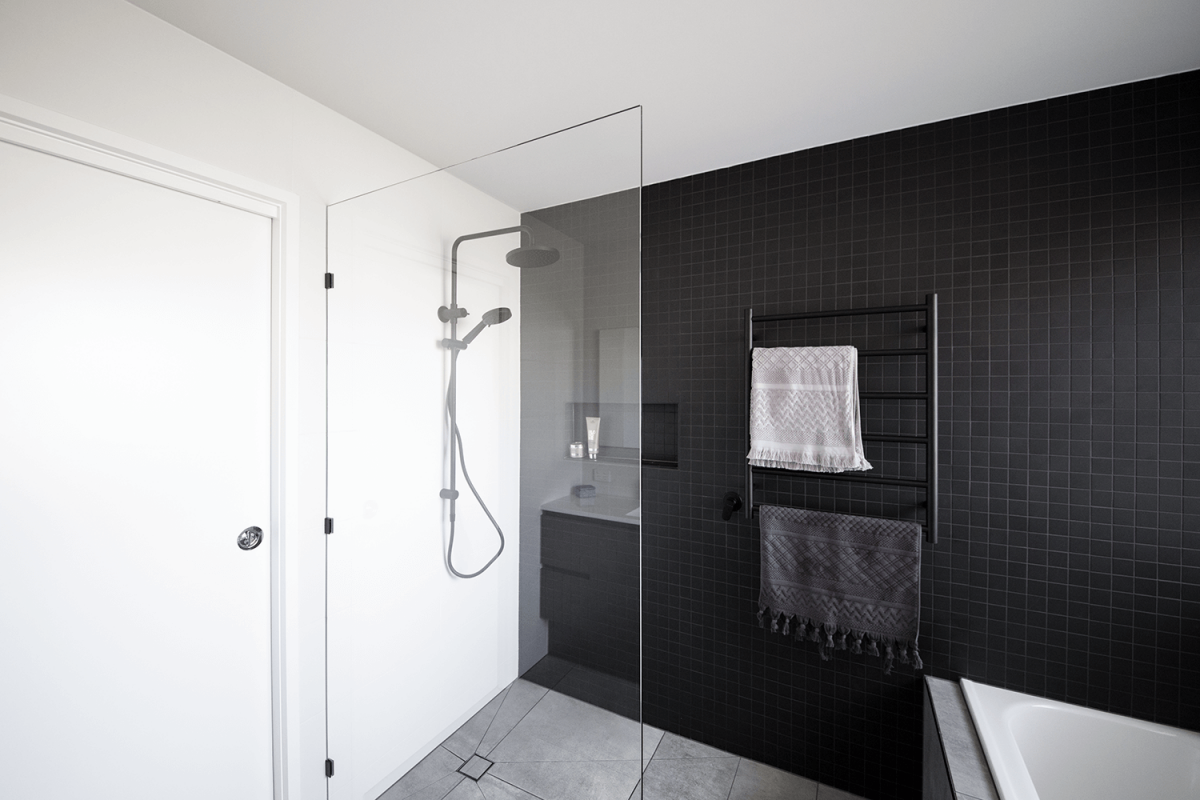 A custom designed bathroom featuring dark tones. Designed and built by MJ Harris Group. #MJHxLamondCrt