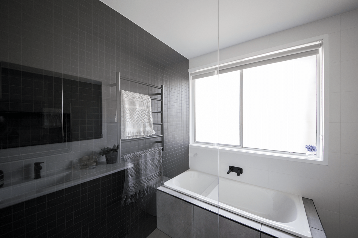 A custom designed bathroom featuring dark tones. Designed and built by MJ Harris Group. #MJHxLamondCrt