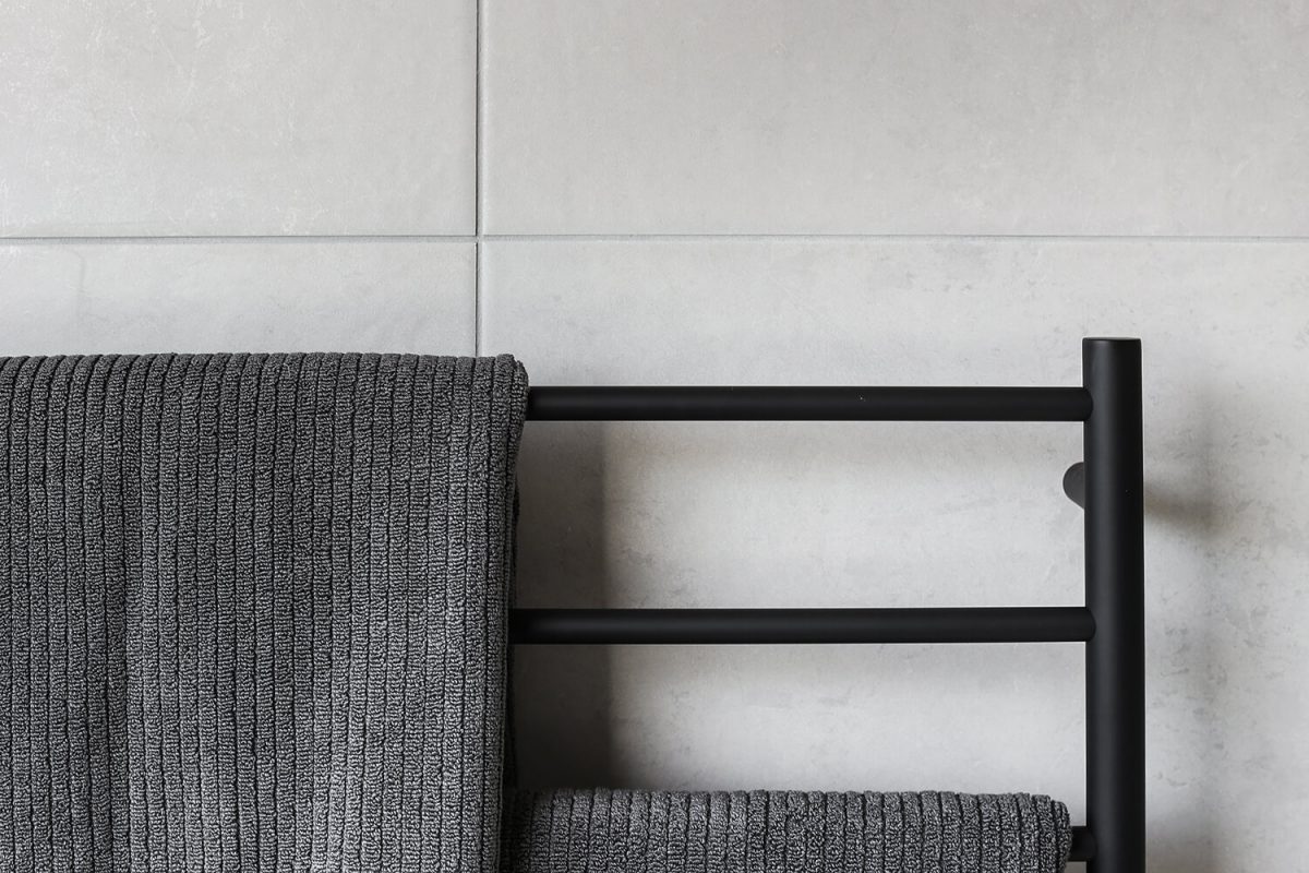 A custom designed bathroom featuring a black towel rail. Designed and built by MJ Harris Group. #MJHxDryCreekDr