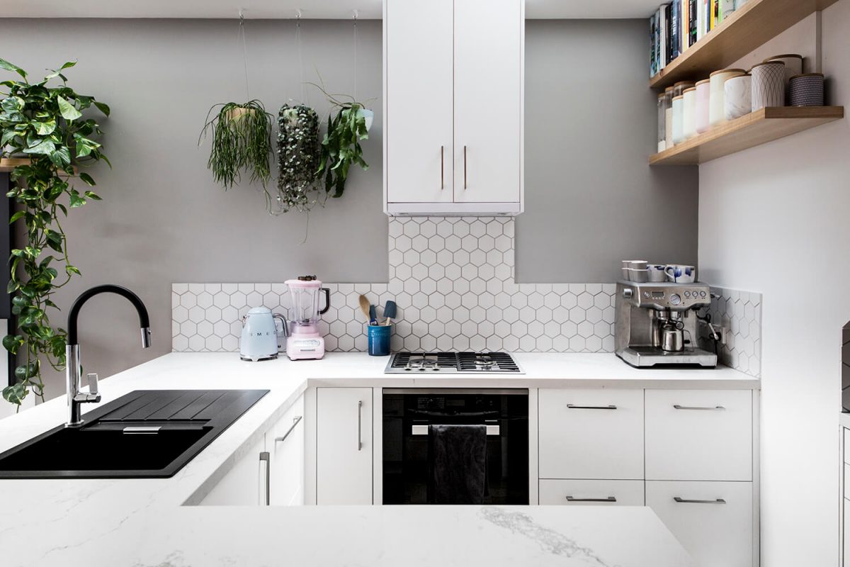 A custom designed kitchen featuring a hexagon tile splashback. Designed and built by MJ Harris Group.