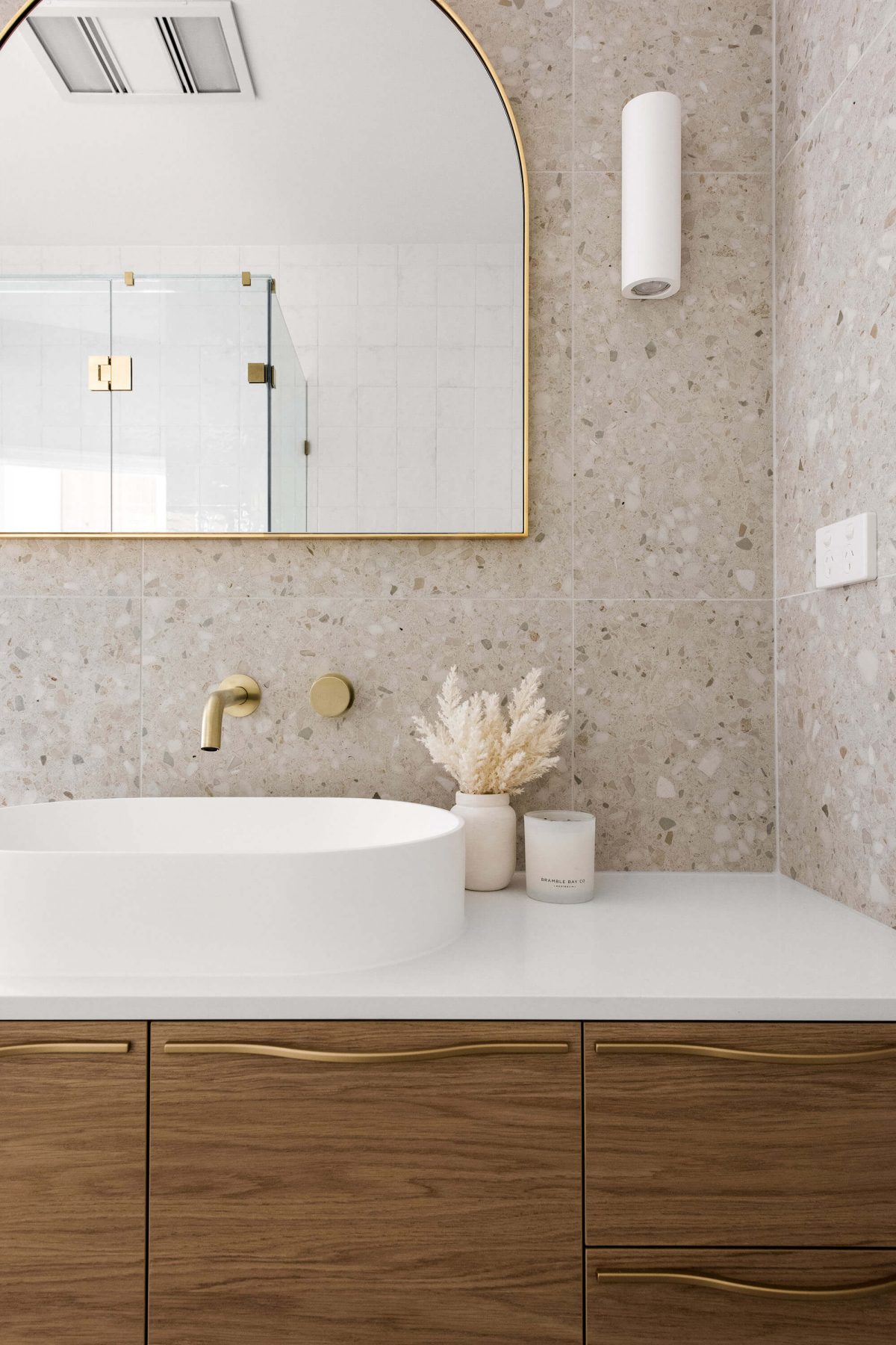 A custom designed bathroom featuring gold accents. Designed and built by MJ Harris Group.