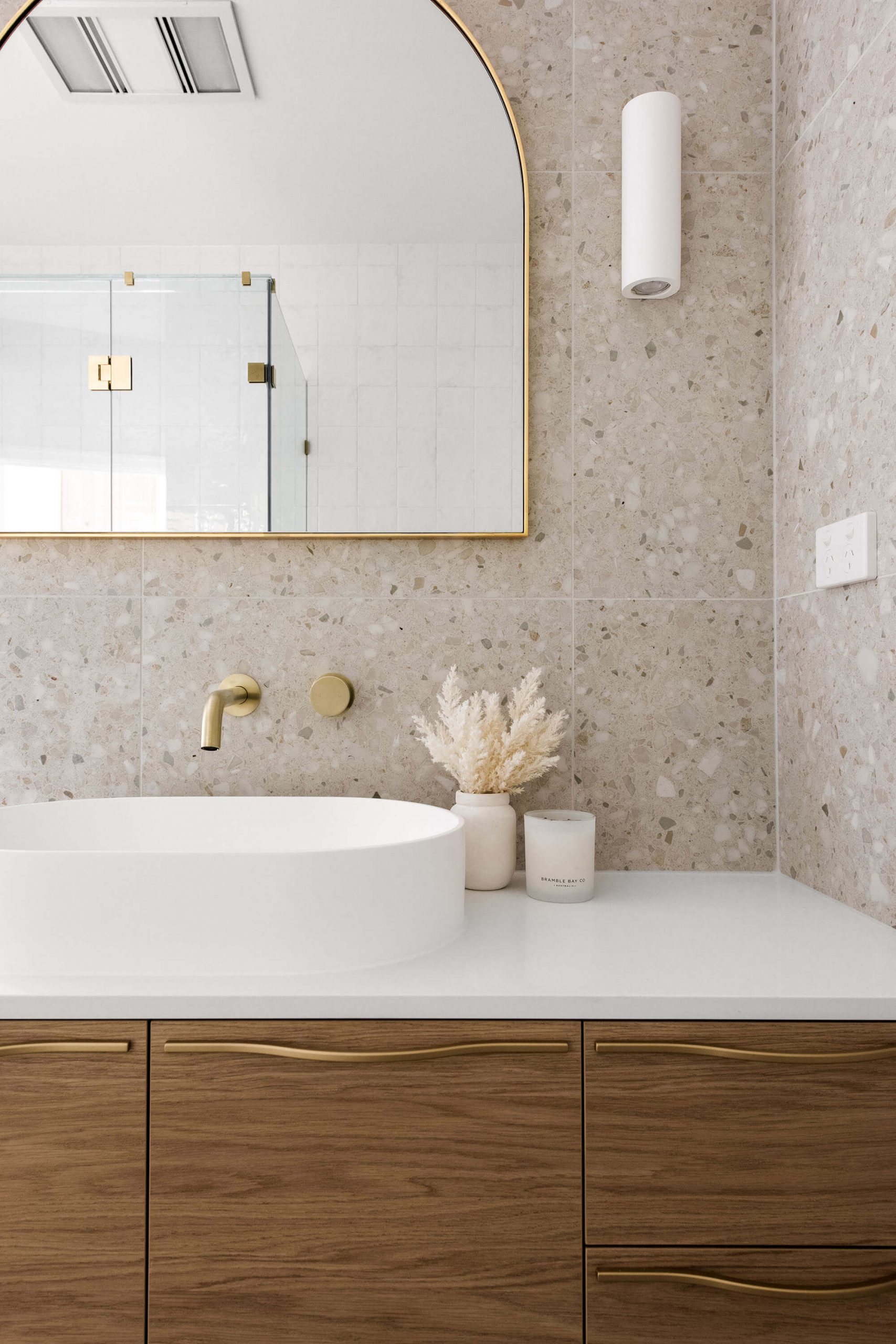 A custom designed bathroom featuring gold accents. Designed and built by MJ Harris Group.