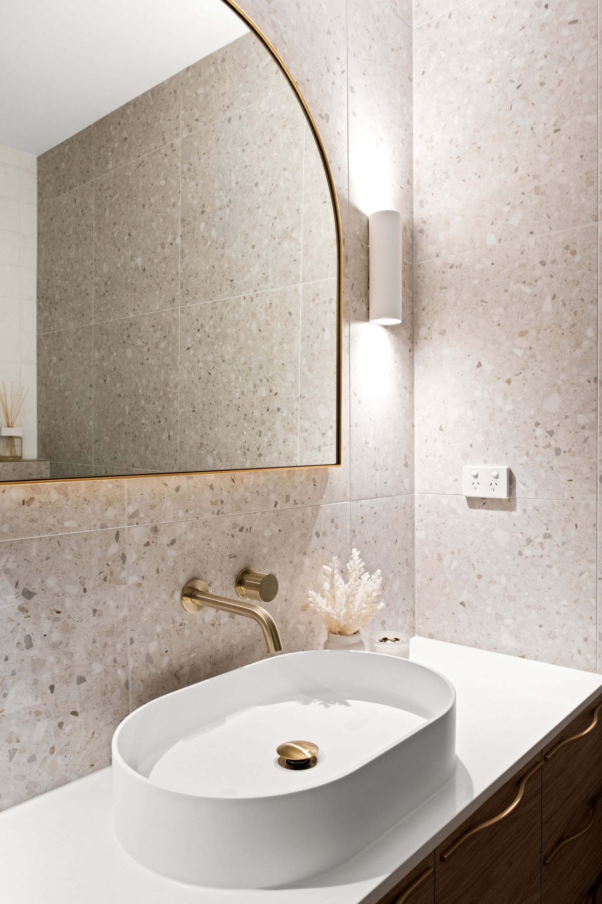 A custom designed bathroom featuring gold accents. Designed and built by MJ Harris Group.